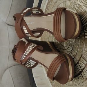Brown wedges with wrap around ankle buckle strap.